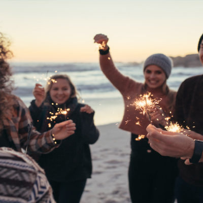 People holding sparklers on the beach