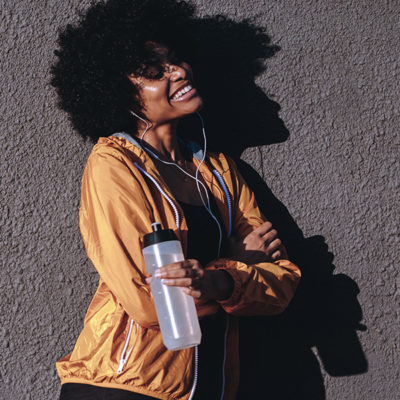 girl smiling with a water bottle