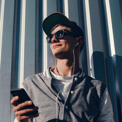 Guy Smirking with a Phone in Hand