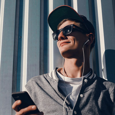 Guy Smirking with a Phone in Hand