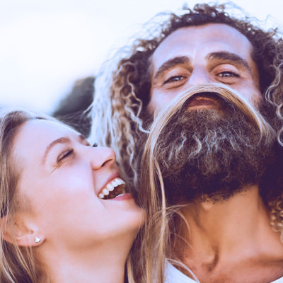 Couple laughing with hair making a beard.