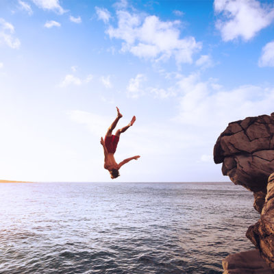 Man flipping off a cliff.