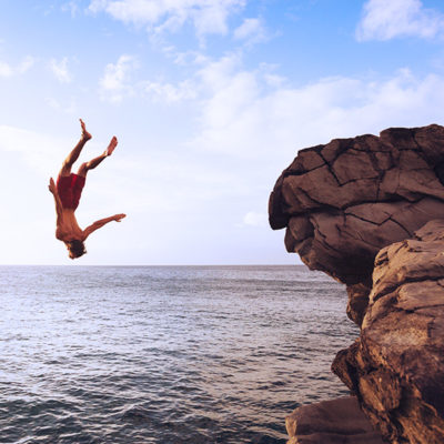 Man flipping off a cliff.