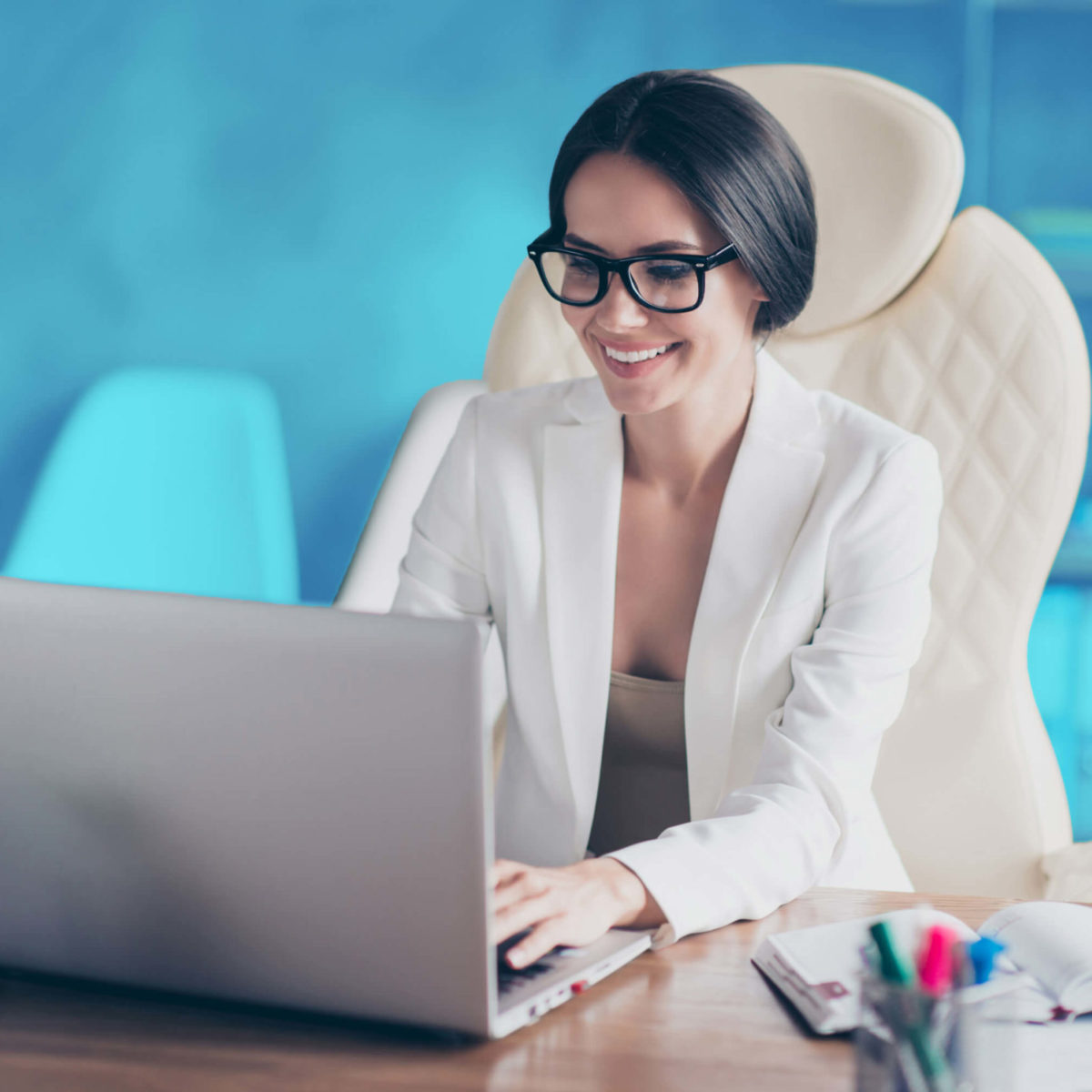 A woman works on designing a landing page on her laptop.