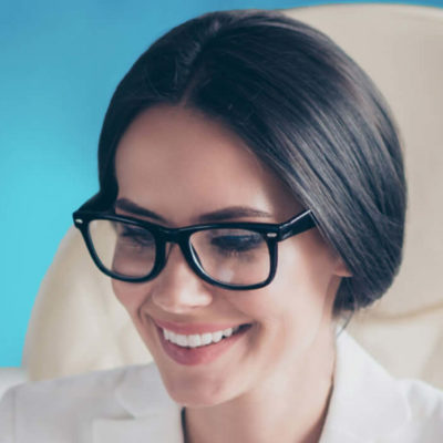 A woman works on designing a landing page on her laptop.