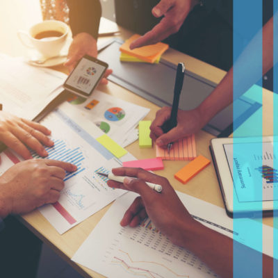 Coworkers create actionable content on a worktable.