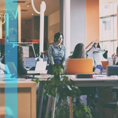 A group of women have a conversation about SEO in a modern office space.