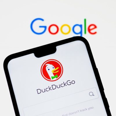 DuckDuckGo app on a smartphone screen next to Google search page