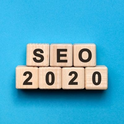 SEO 2020 text on wooden cubes on a blue background