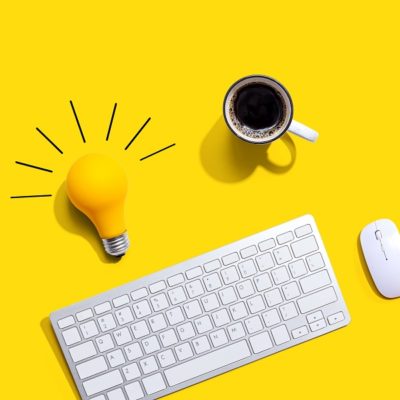 Computer keyboard with a yellow light bulb
