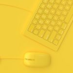 Minimal idea concept. Mouse beside keyboard yellow color.