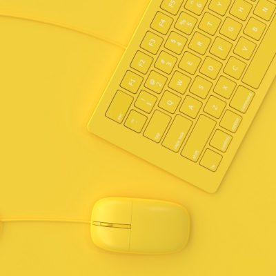 Minimal idea concept. Mouse beside keyboard yellow color.