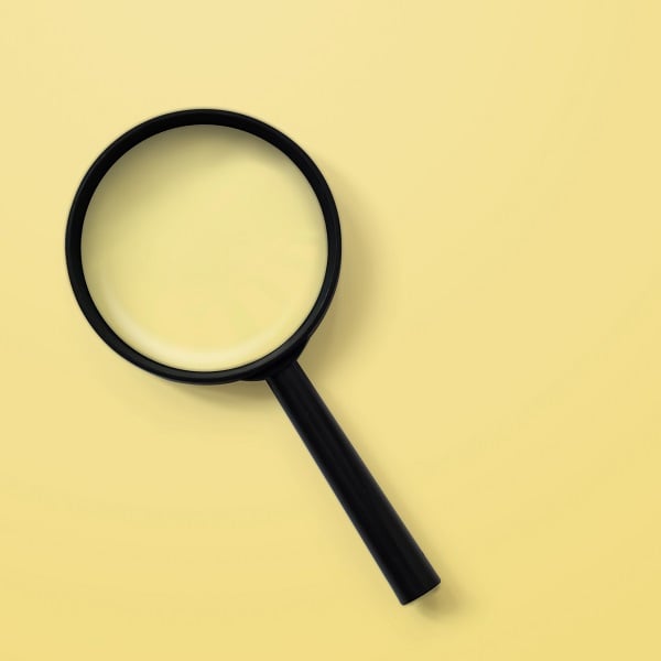 Magnifying glass on yellow colour background. Searching information data concept