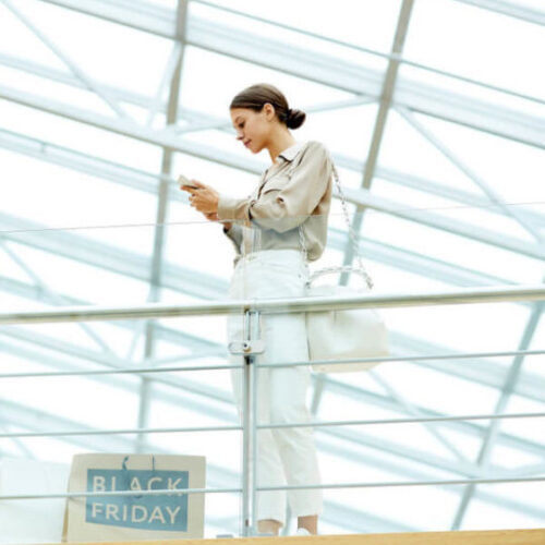 A woman looks at content on her phone.