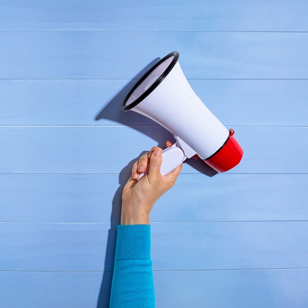 Person holding a megaphone Hand holding a megaphone.
