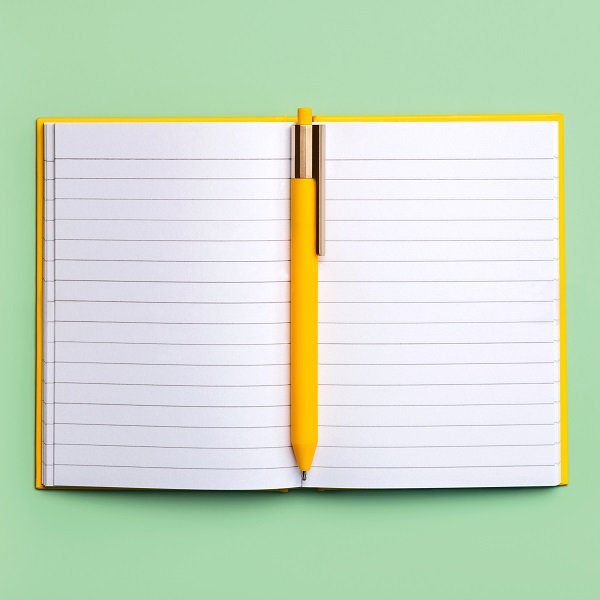 Open diary with copy space and yellow pen.Workspace desk Open diary with copy space and yellow pen.Workspace desk