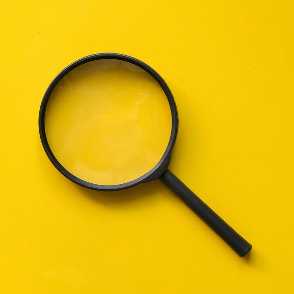 close up magnifier glass on yellow background close up magnifier glass on yellow background