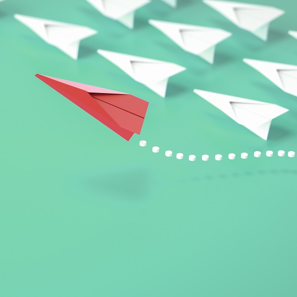 paper plane leadership concept - red paper plane leading the row